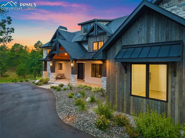 a front view of a house with garden space and patio