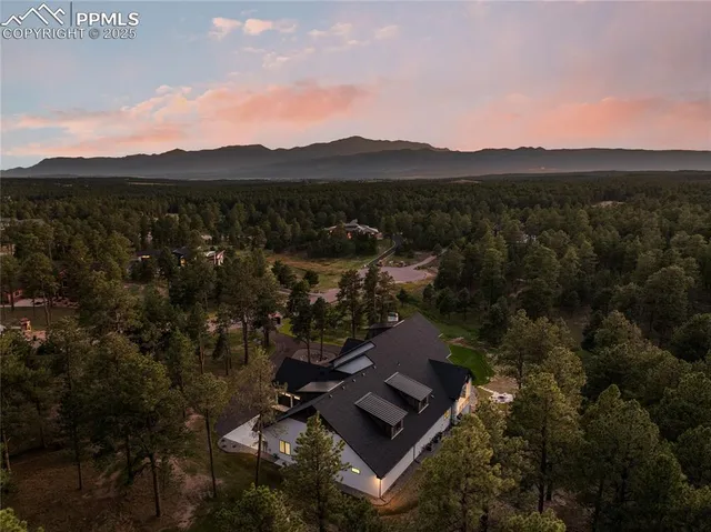 an aerial view of a house with a yard pool a patio and outdoor seating