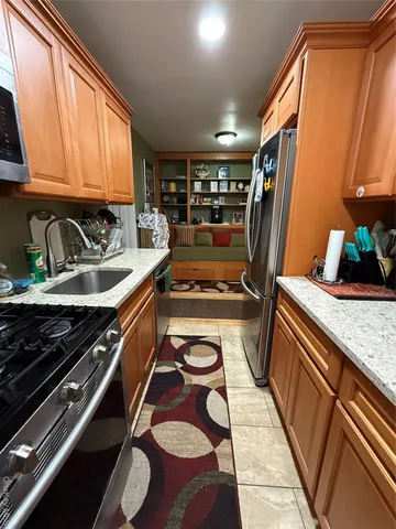 a kitchen with wooden cabinets and a sink