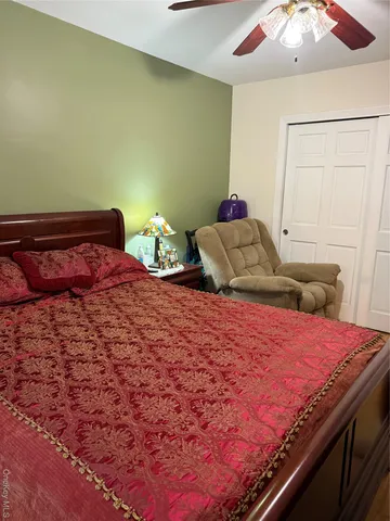 a bedroom with a bed and a chandelier