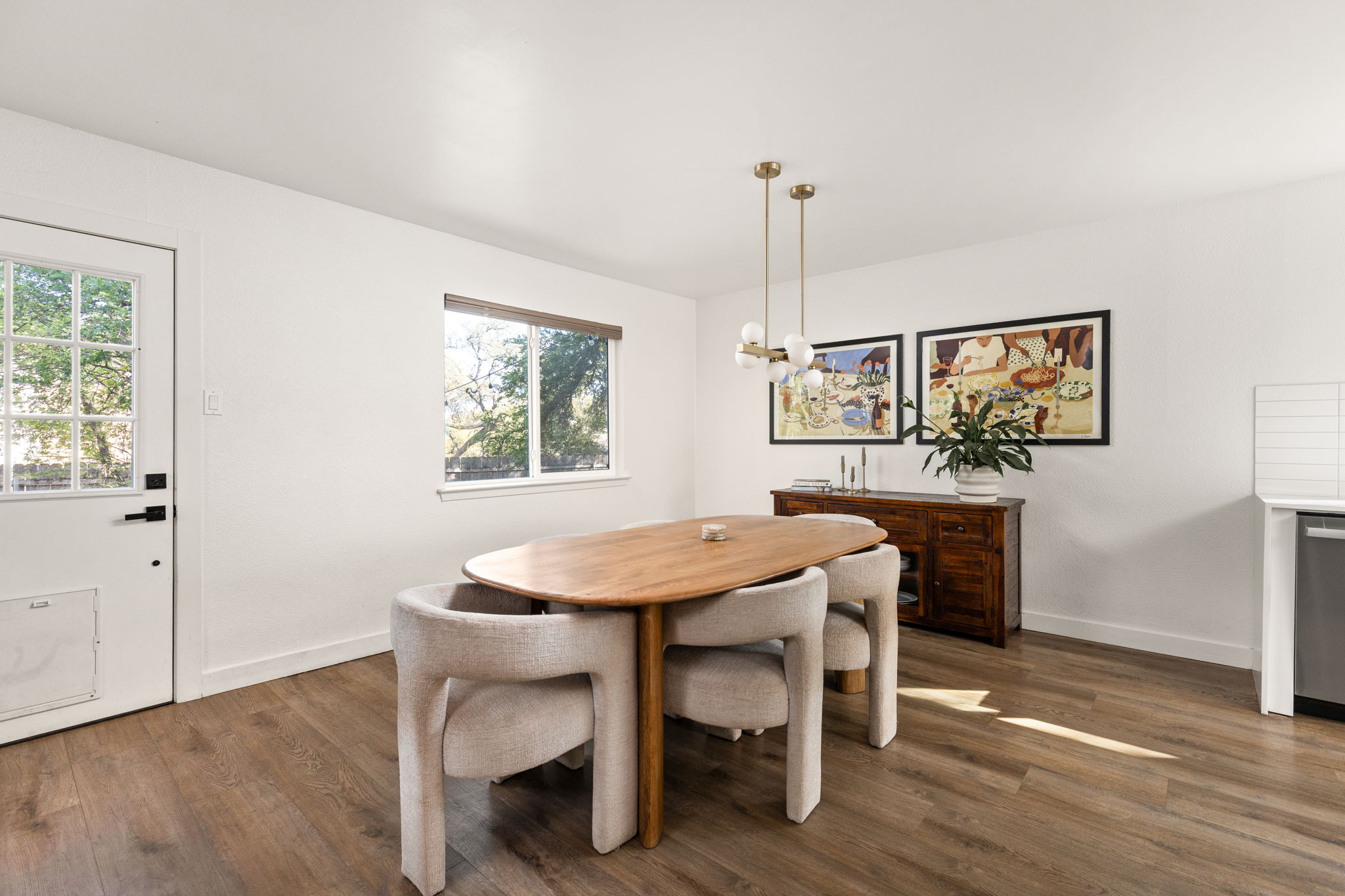 7909 Manassas Drive Austin, TX 78745 - Photo 16 of 37 Dining area featuring dark wood-style flooring and hanging lights