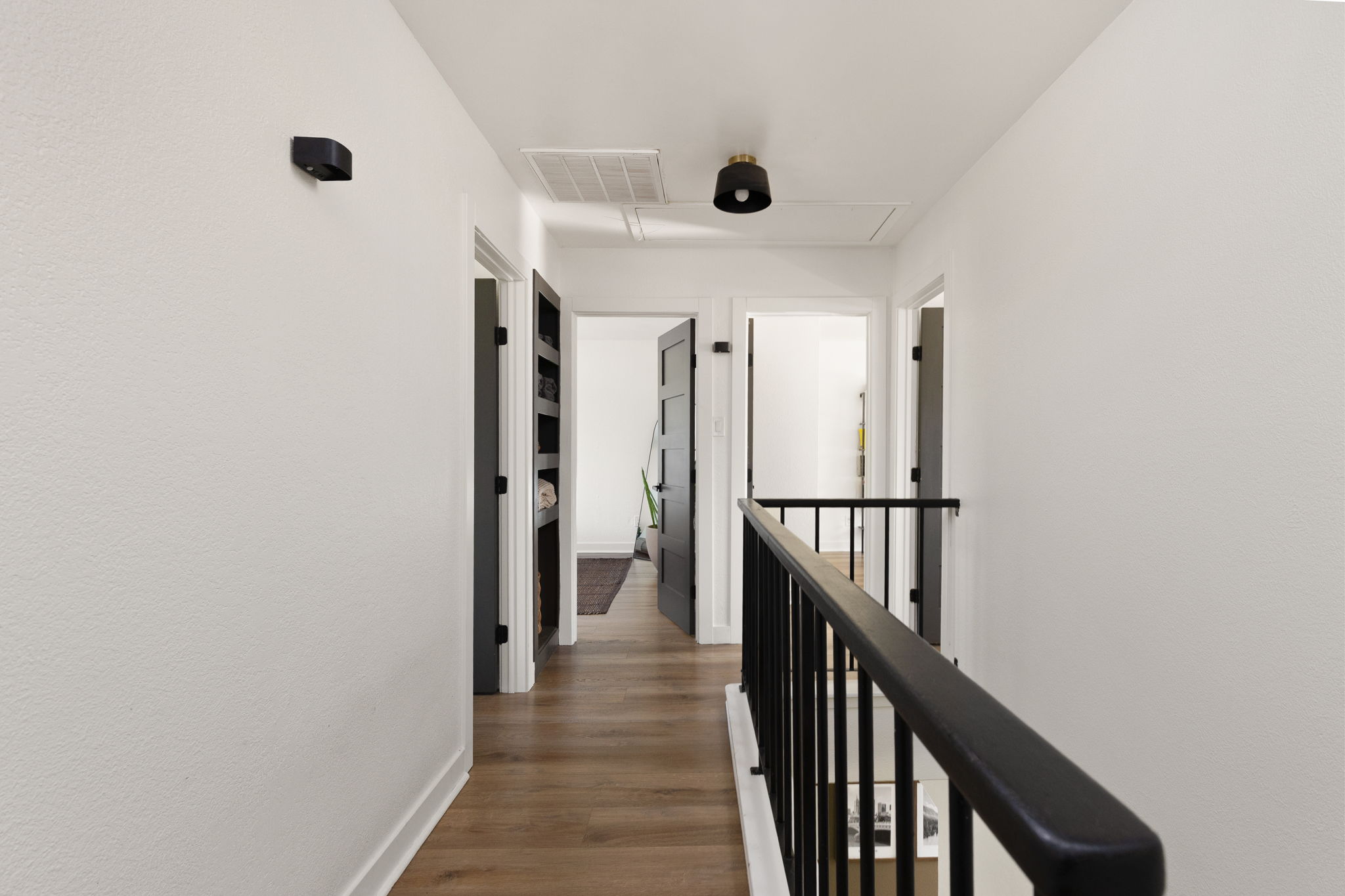 7909 Manassas Drive Austin, TX 78745 - Photo 26 of 37 Corridor featuring an upstairs landing and dark wood finished floors