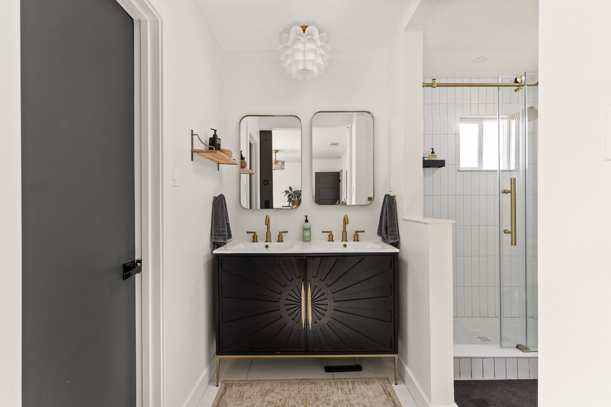 7909 Manassas Drive Austin, TX 78745 - Photo 29 of 37 Bathroom featuring double vanity, a stall shower, and light tile patterned flooring