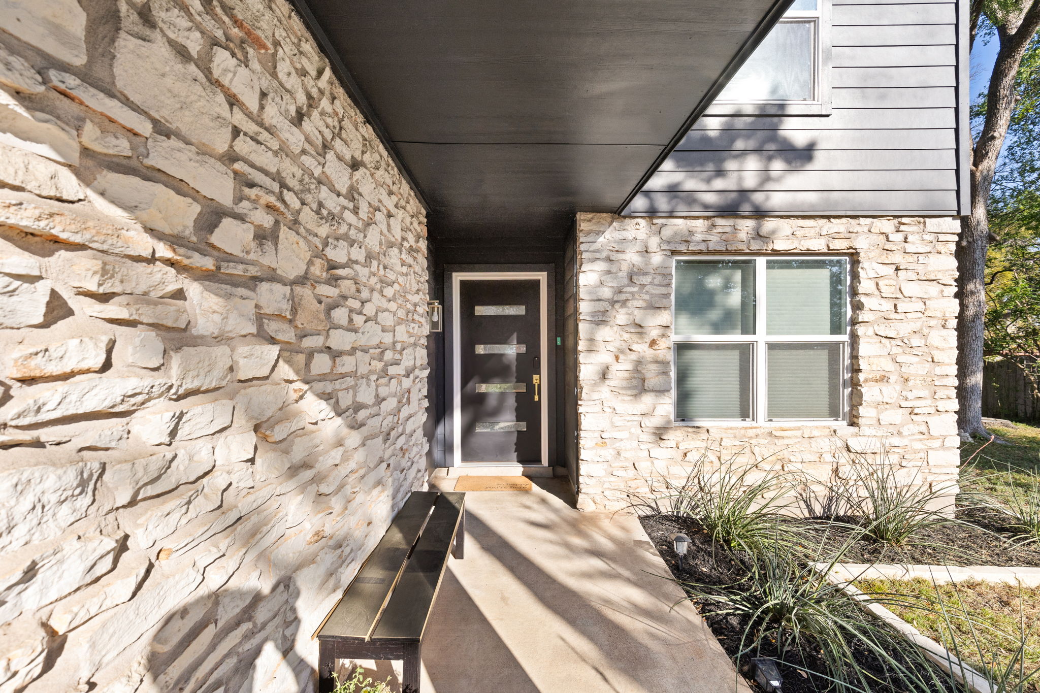 7909 Manassas Drive Austin, TX 78745 - Photo 4 of 37 Property entrance featuring stone siding