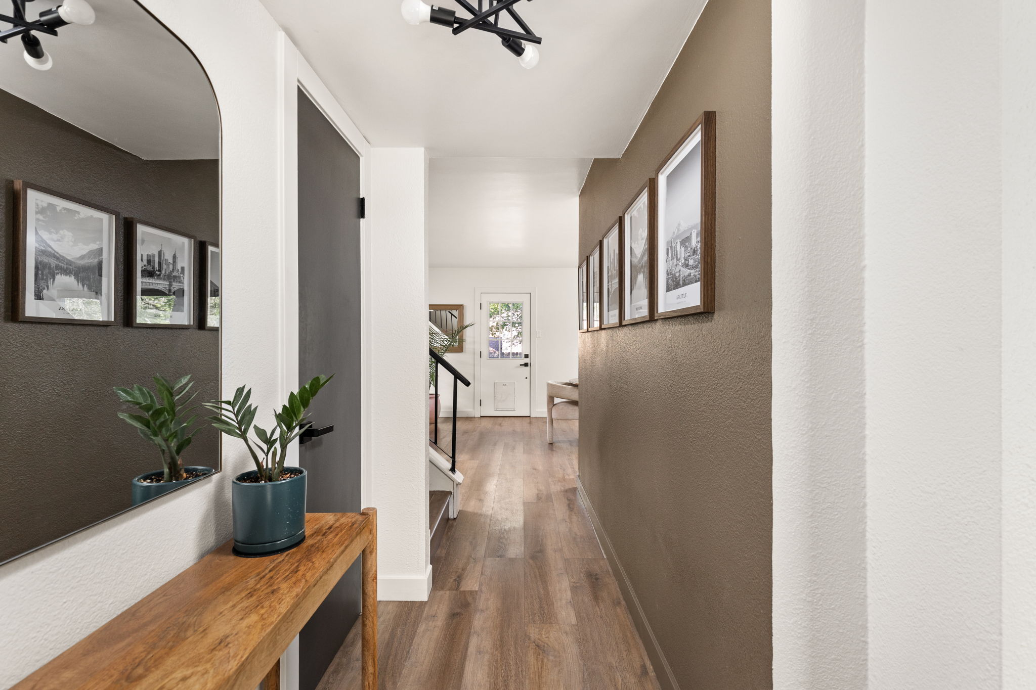 7909 Manassas Drive Austin, TX 78745 - Photo 5 of 37 Corridor featuring dark wood-style floors and a textured wall