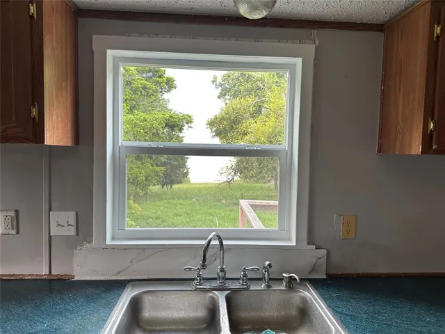 a spacious bathroom with a double vanity sink mirror and bathtub