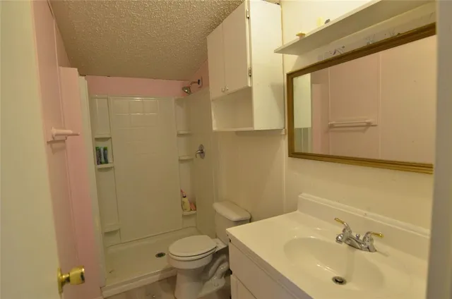 a kitchen with kitchen island granite countertop a stove a sink and a refrigerator