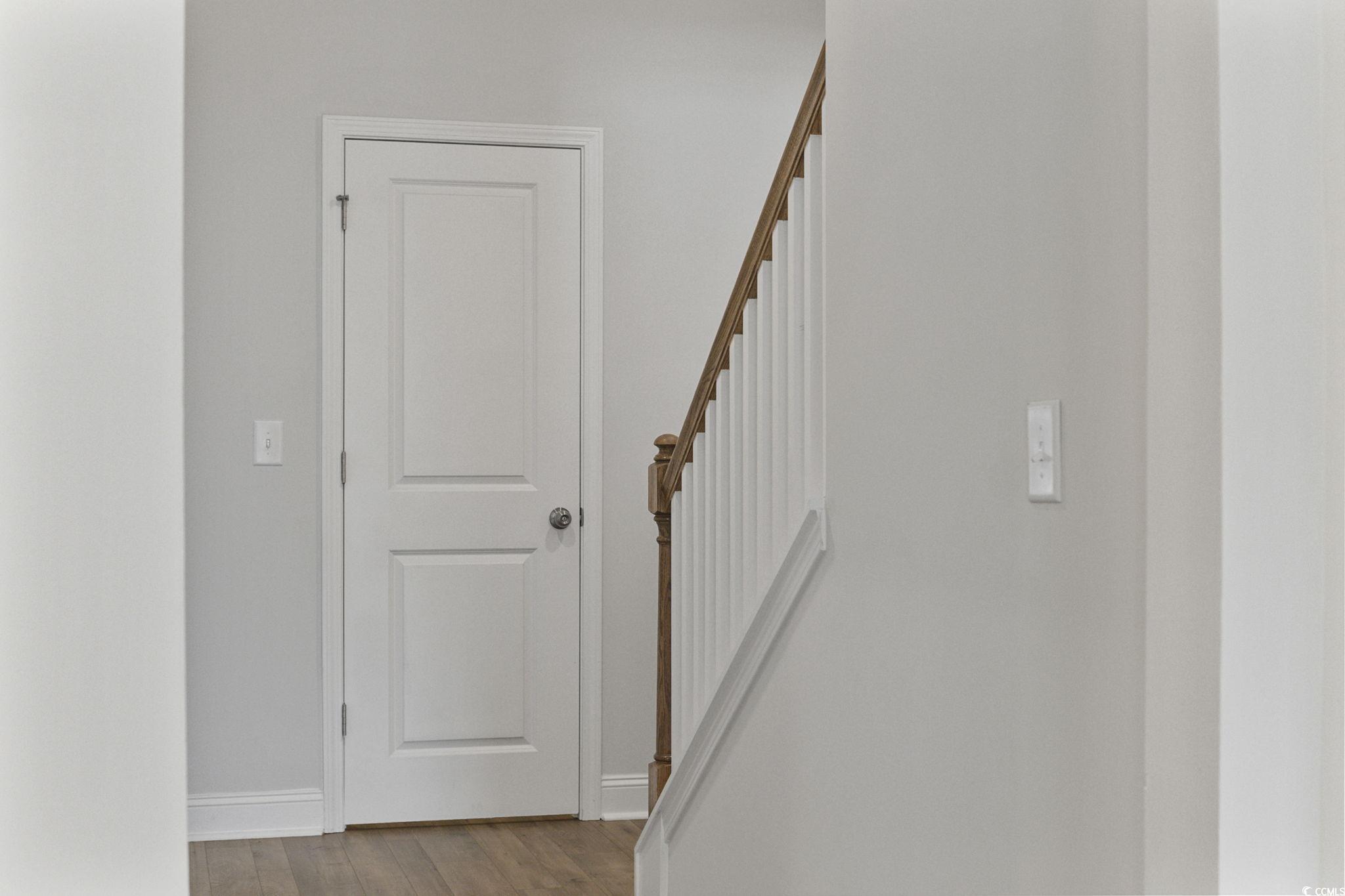 2595 Blue Crane Circle, Unit 102 Myrtle Beach, SC 29577 - Photo 12 of 40 Stairs with wood finished floors and baseboards