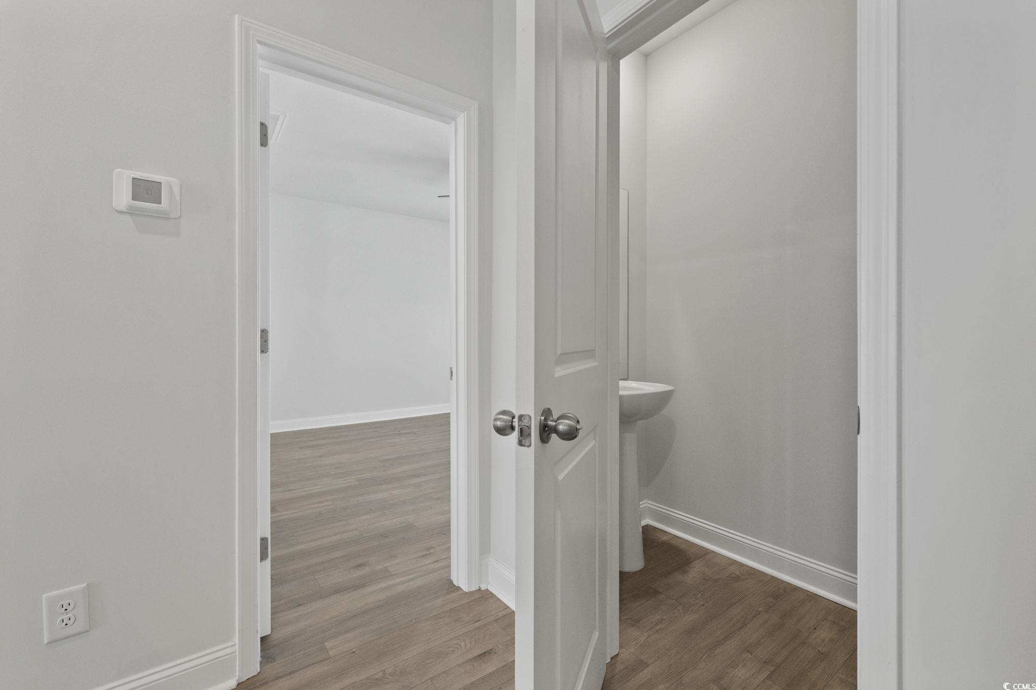 2595 Blue Crane Circle, Unit 102 Myrtle Beach, SC 29577 - Photo 14 of 40 Hall featuring baseboards and light wood-style floors