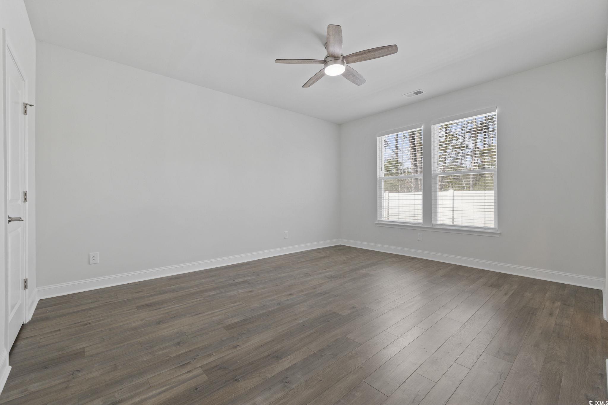 2595 Blue Crane Circle, Unit 102 Myrtle Beach, SC 29577 - Photo 15 of 40 Spare room featuring dark wood-type flooring and ceiling fan