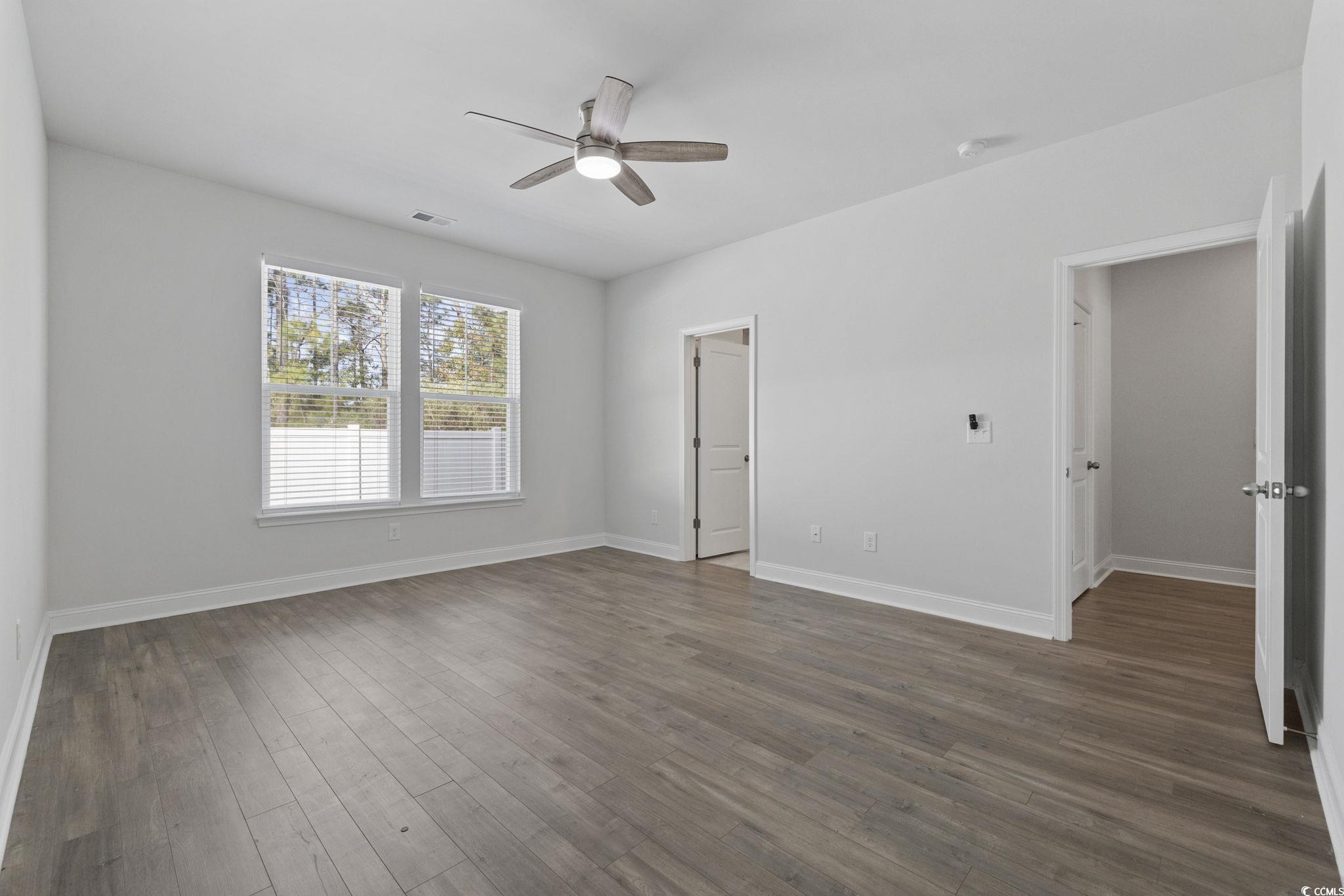2595 Blue Crane Circle, Unit 102 Myrtle Beach, SC 29577 - Photo 17 of 40 Spare room featuring dark wood-style floors and ceiling fan