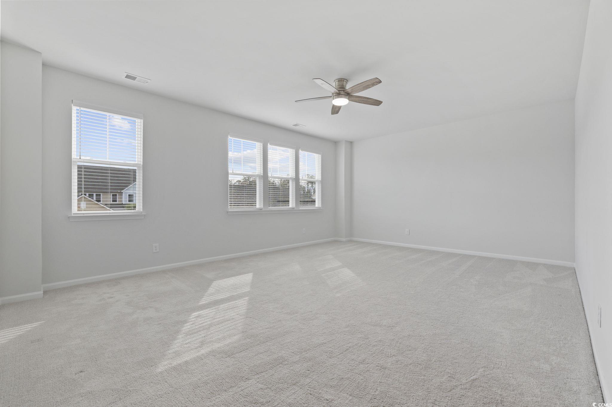 2595 Blue Crane Circle, Unit 102 Myrtle Beach, SC 29577 - Photo 23 of 40 Carpeted empty room with baseboards and a ceiling fan