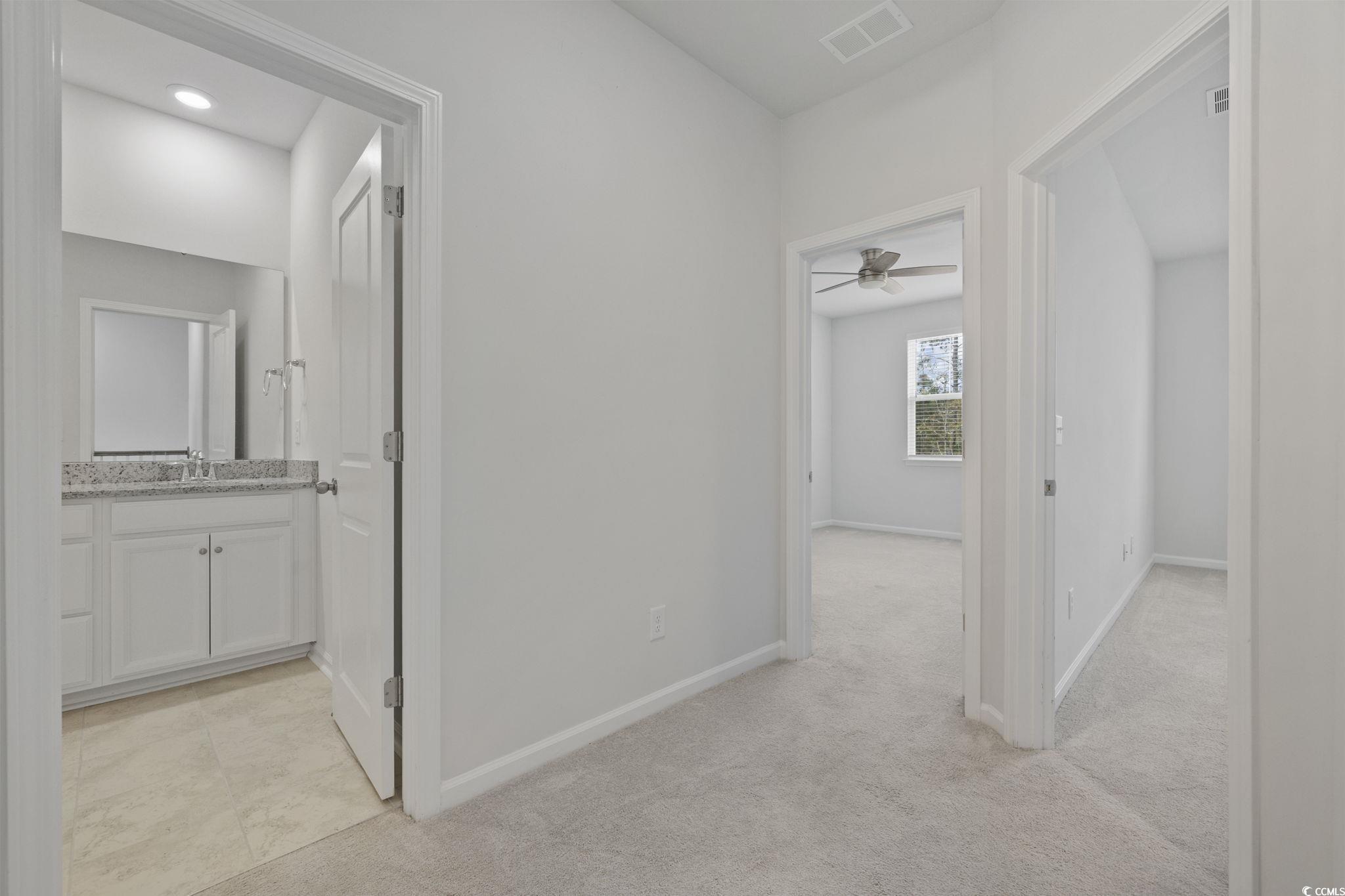 2595 Blue Crane Circle, Unit 102 Myrtle Beach, SC 29577 - Photo 26 of 40 Corridor with light carpet and baseboards