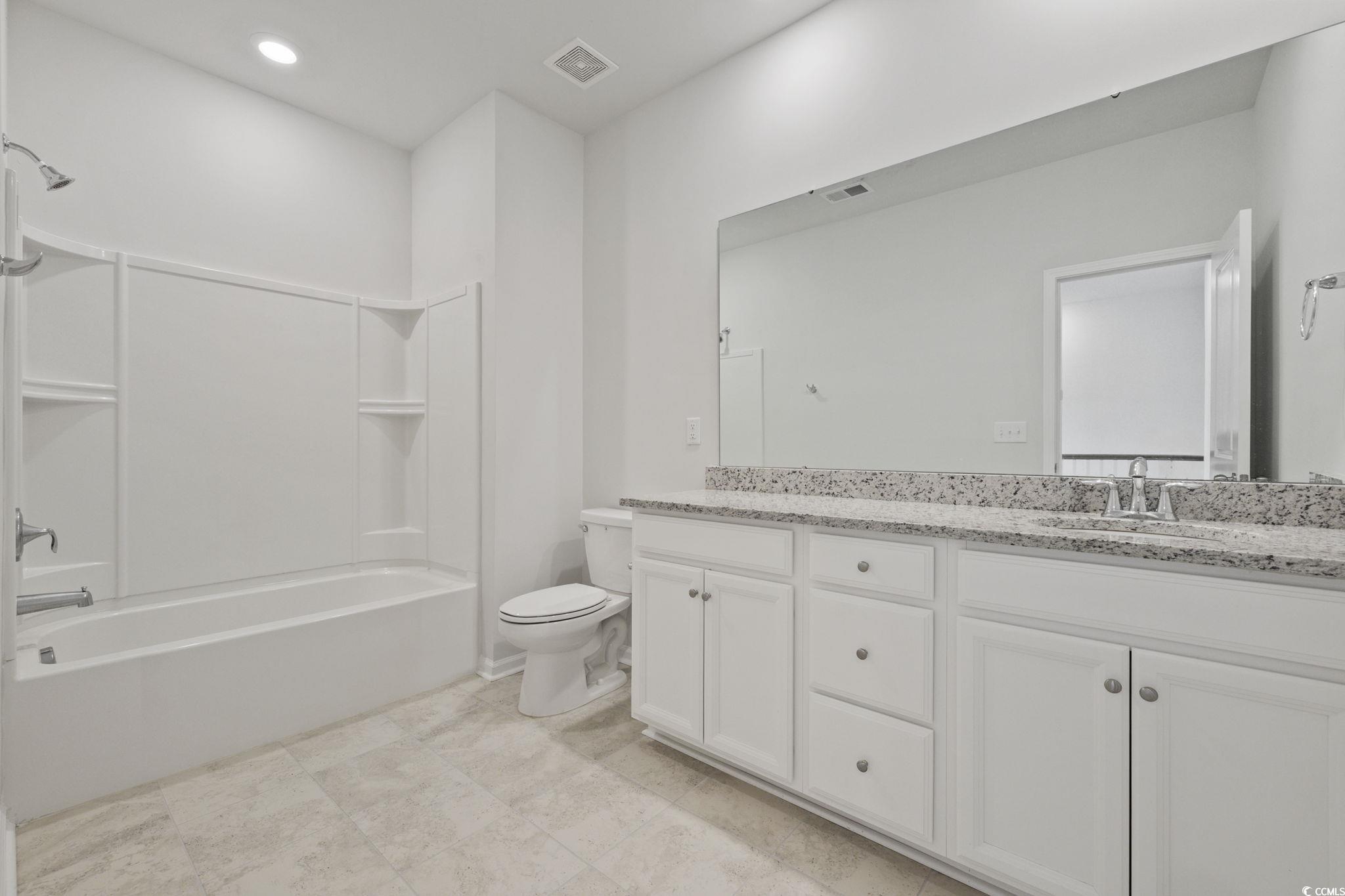 2595 Blue Crane Circle, Unit 102 Myrtle Beach, SC 29577 - Photo 27 of 40 Full bathroom featuring double vanity, shower combination, and recessed lighting