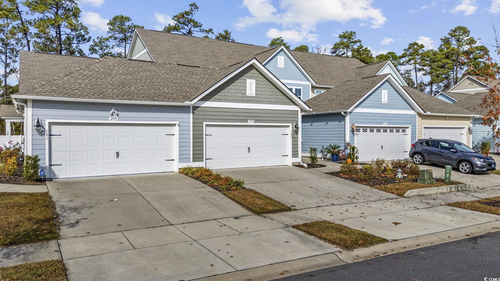 2595 Blue Crane Circle, Unit 102 Myrtle Beach, SC 29577 - Photo 3 of 40 View of front of house featuring a shingled roof and concrete driveway