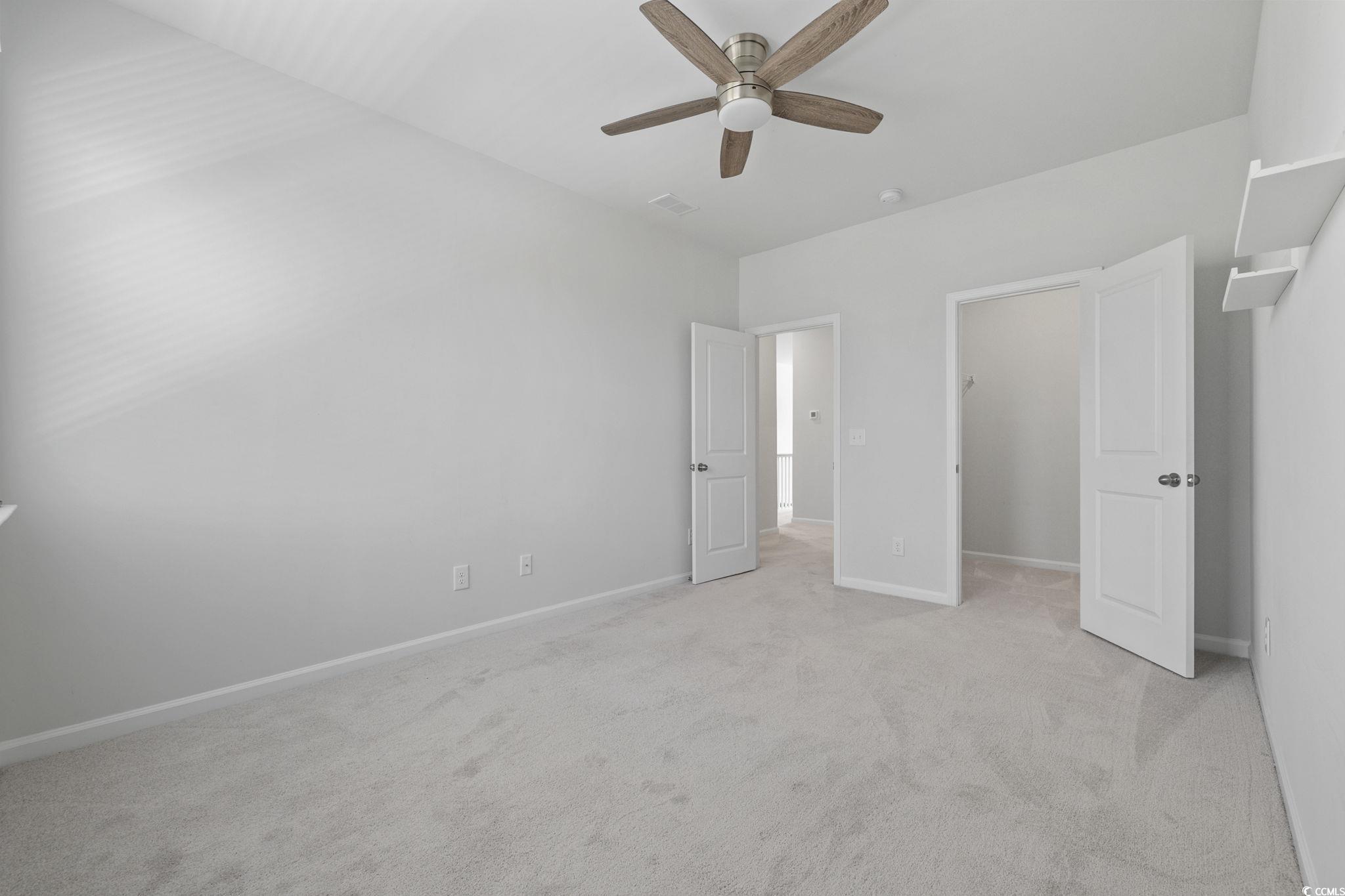 2595 Blue Crane Circle, Unit 102 Myrtle Beach, SC 29577 - Photo 33 of 40 Unfurnished bedroom featuring light carpet and ceiling fan