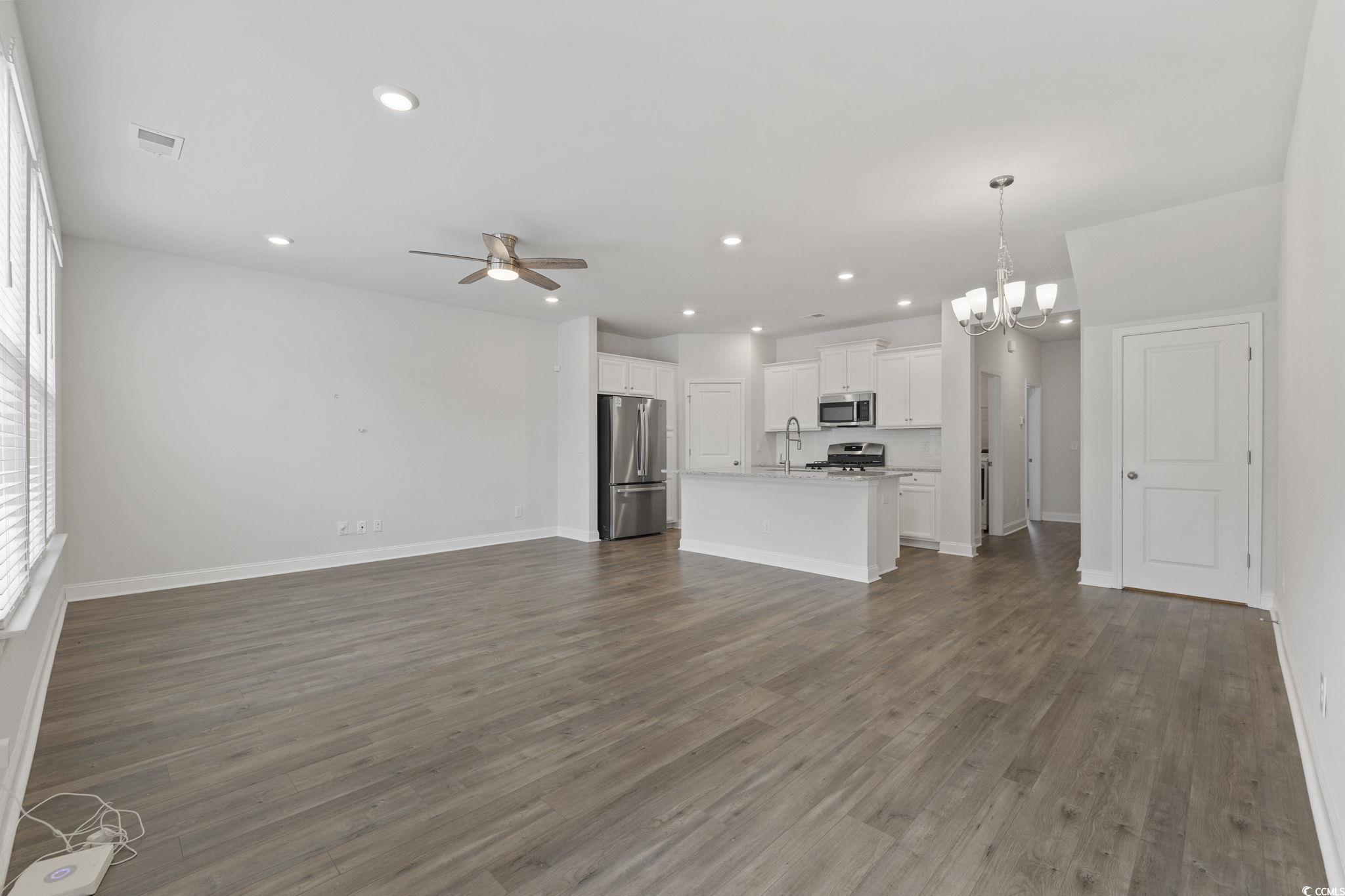 2595 Blue Crane Circle, Unit 102 Myrtle Beach, SC 29577 - Photo 6 of 40 Unfurnished living room with recessed lighting, a chandelier, a ceiling fan, and dark wood finished floors