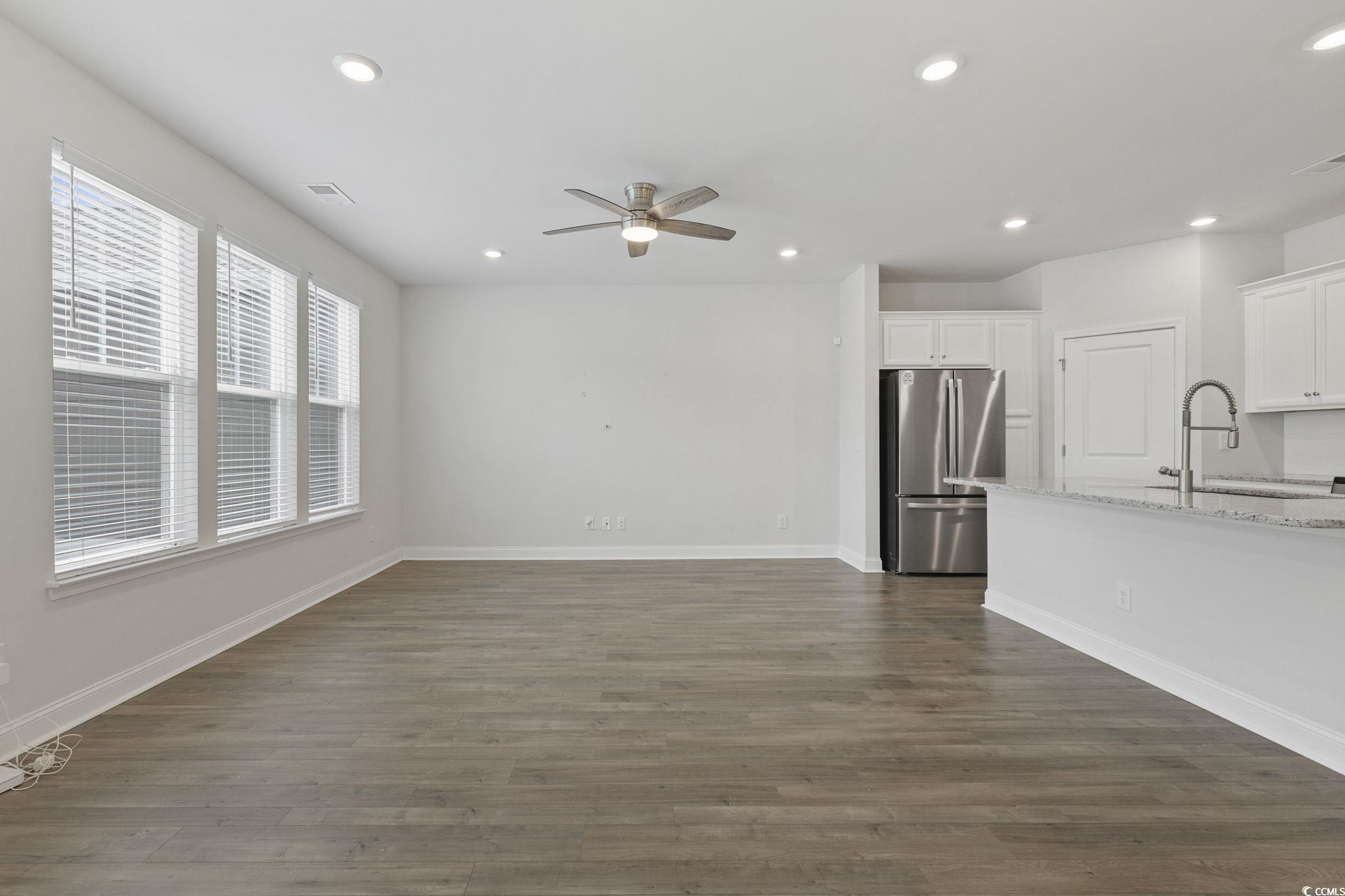 2595 Blue Crane Circle, Unit 102 Myrtle Beach, SC 29577 - Photo 7 of 40 Unfurnished living room with dark wood-style floors, recessed lighting, and ceiling fan