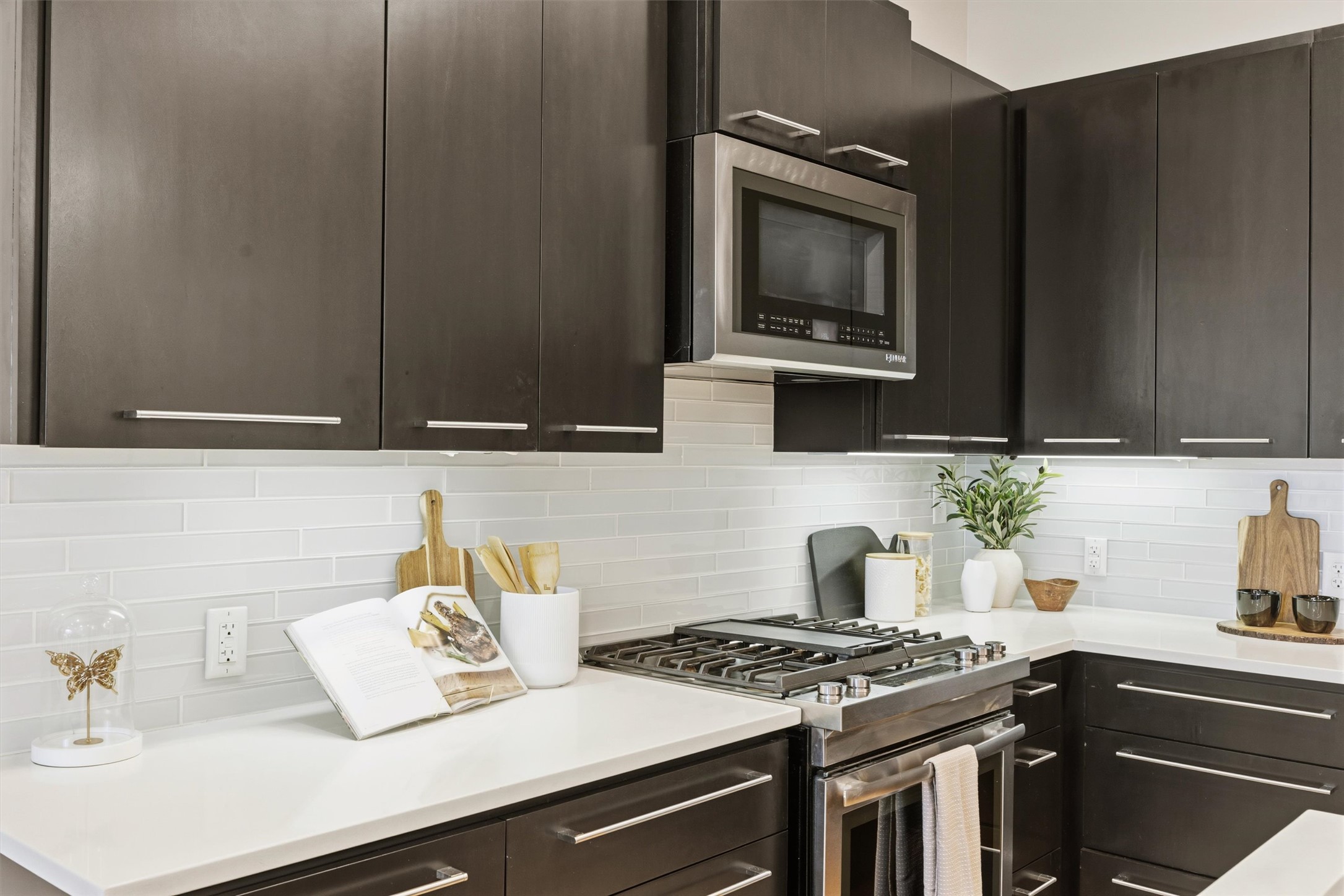 2314 Enfield Road, Unit 203 Austin, TX 78703 - Photo 6 of 37 A gas range and subway tile backsplash bring the full chef-kitchen experience to condo living.