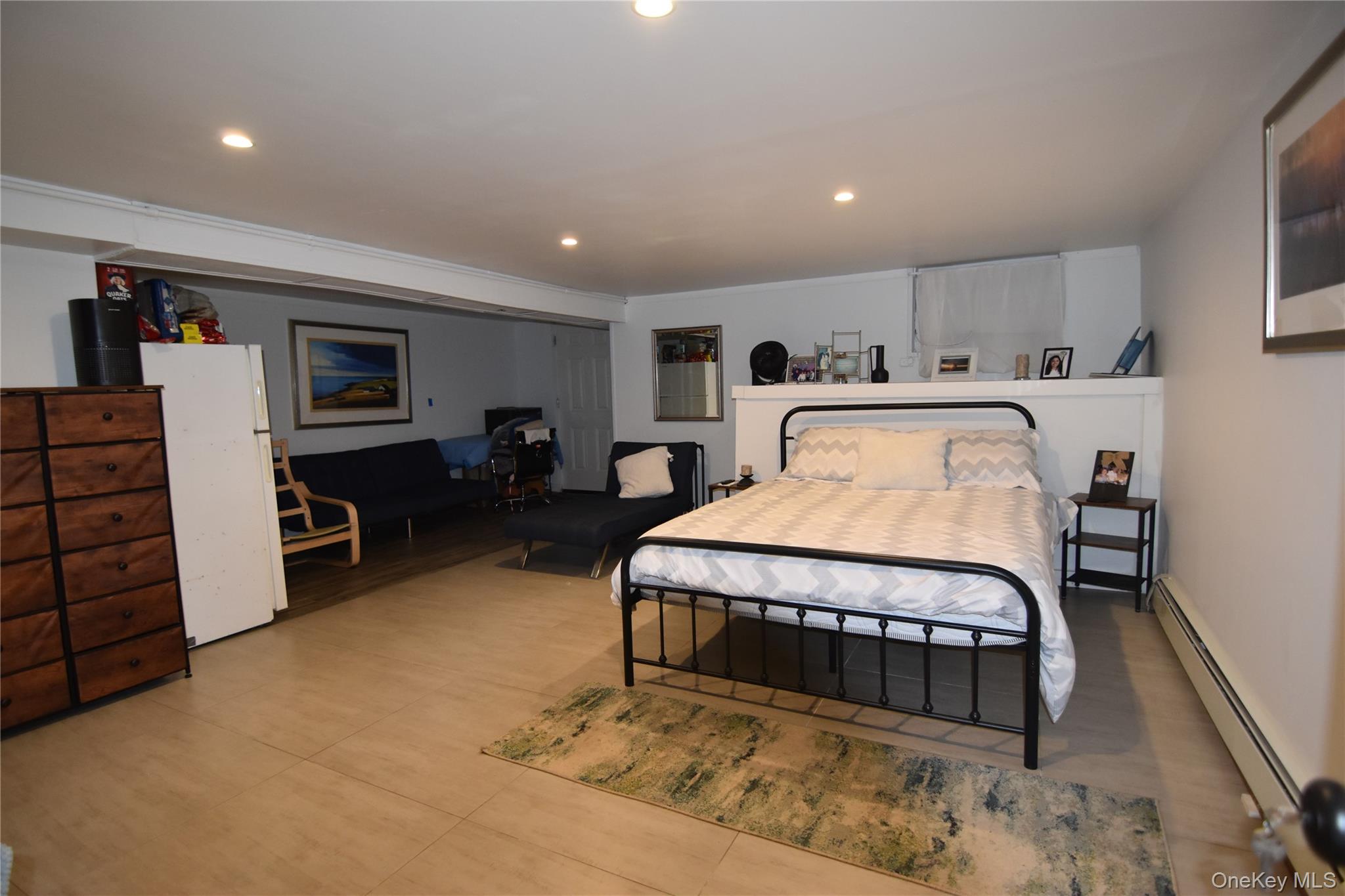 25-48 89th Street Queens, NY 11369 - Photo 11 of 17 a bed room with a bed and furniture