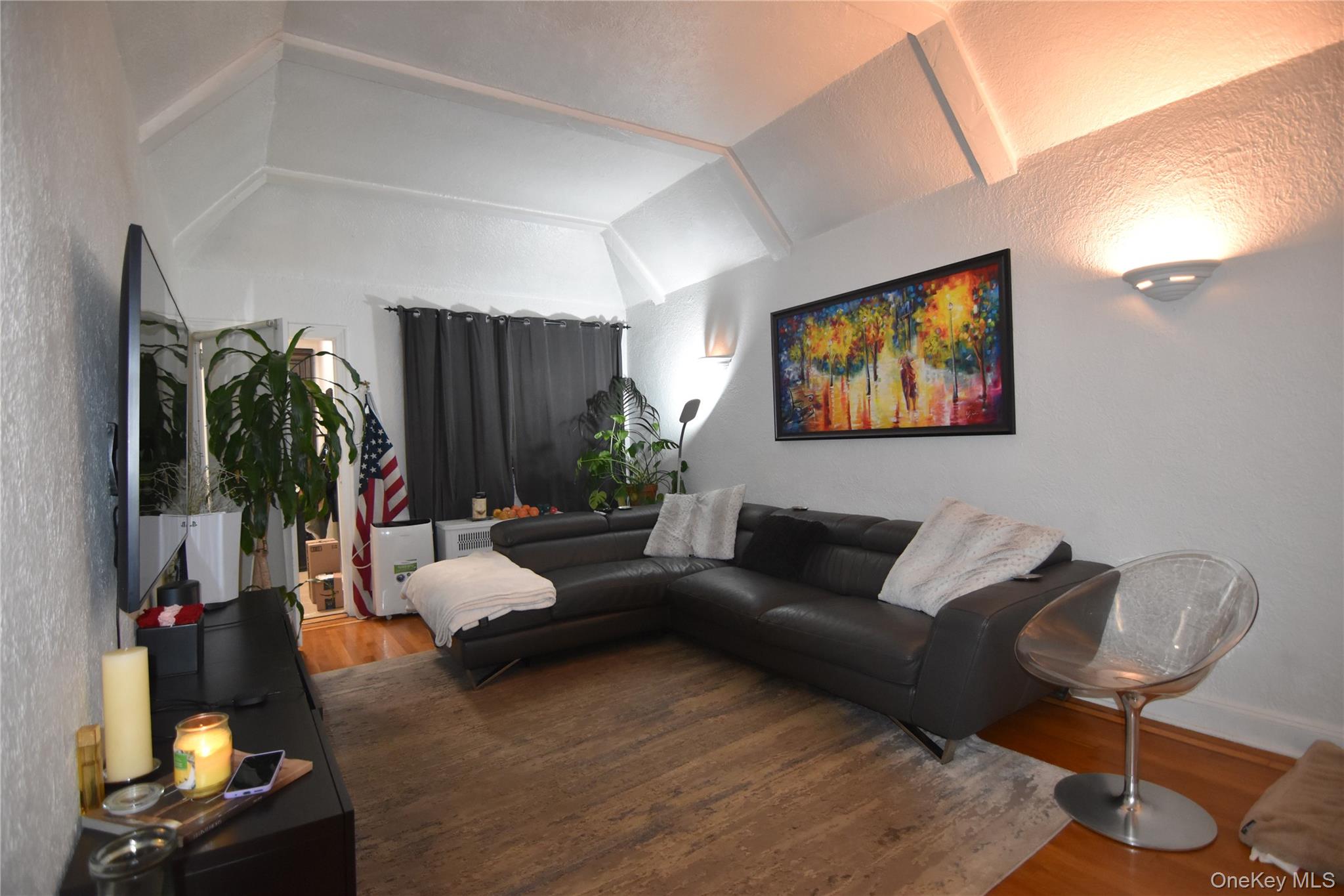 25-48 89th Street Queens, NY 11369 - Photo 6 of 17 a living room with furniture and a flat screen tv