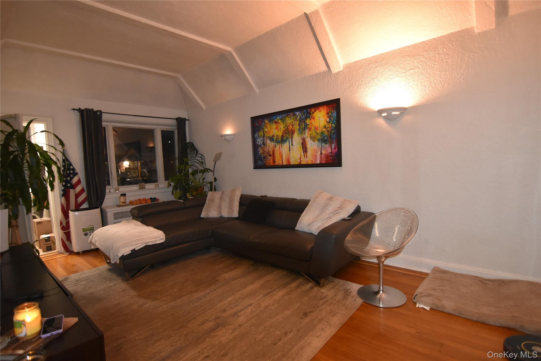 25-48 89th Street Queens, NY 11369 - Photo 7 of 17 a living room with furniture and a wooden floor