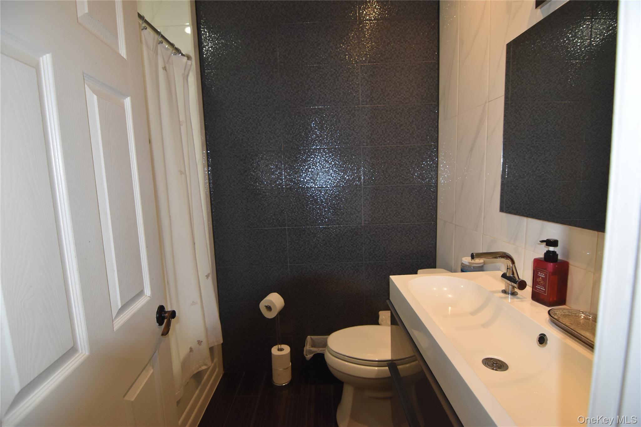 25-48 89th Street Queens, NY 11369 - Photo 9 of 17 a bathroom with a sink toilet and shower