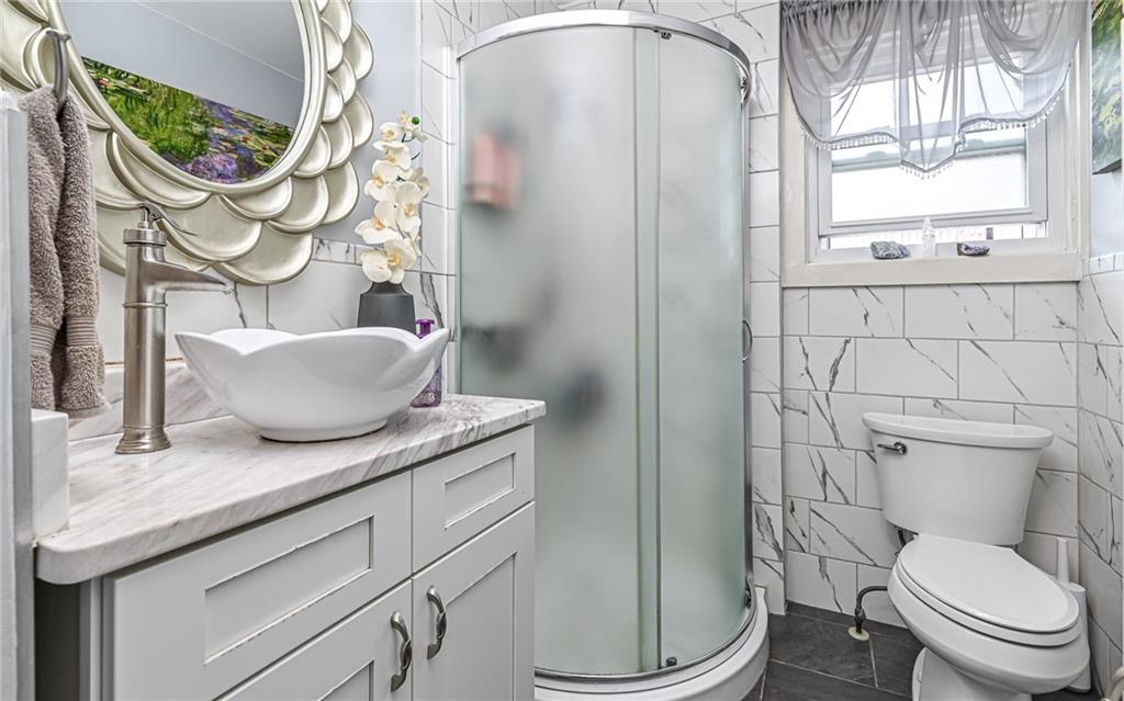 164 45th Street Pittsburgh, PA 15201 - Photo 19 of 47 a bathroom with a granite countertop toilet sink and mirror