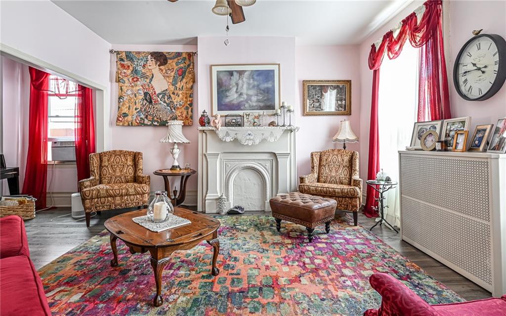 164 45th Street Pittsburgh, PA 15201 - Photo 6 of 47 a living room with furniture a rug and a wall painting
