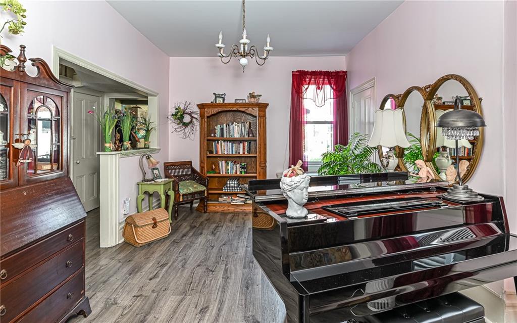164 45th Street Pittsburgh, PA 15201 - Photo 10 of 47 a living room with furniture a chandelier and wooden floor