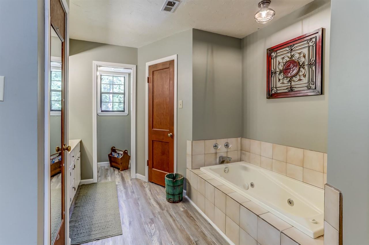 7373 Pleasant Ridge Road Arlington, TN 38002 - Photo 14 of 25 Whirlpool tub, updated flooring, two walk-in closets, freshly painted, linen closet, separate shower and water closet.