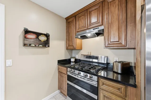 a kitchen with stainless steel appliances granite countertop a stove and a microwave