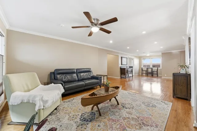 a living room with furniture and a wooden floor
