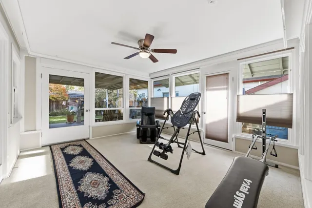 a living room with furniture a flat screen tv and a large window