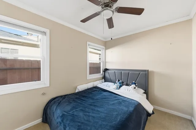 a bed sitting in a bedroom next to a window