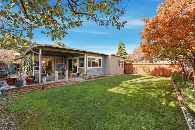 a view of a house with a yard porch and sitting area