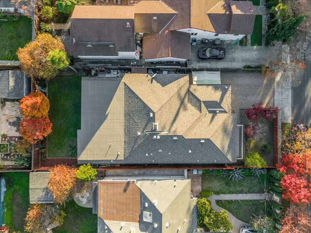 an aerial view of a house with swimming pool and a yard