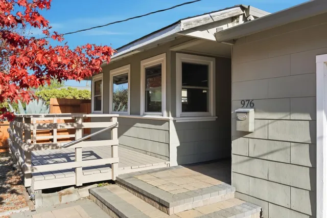 a view of a patio with table and chairs and potted plants