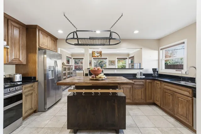 a kitchen with stainless steel appliances granite countertop a stove and a sink