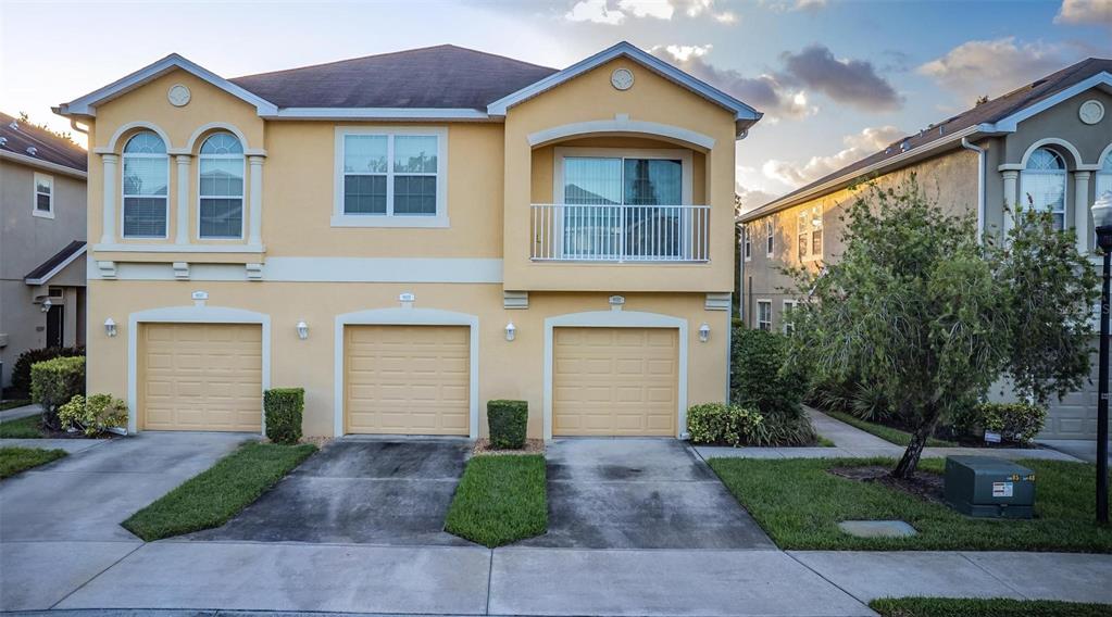 a front view of a house with a yard and garage
