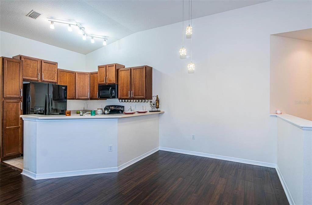 9013 Moonlit Meadows Loop Riverview, FL 33578 - Photo 24 of 43 a kitchen with a refrigerator sink and cabinets