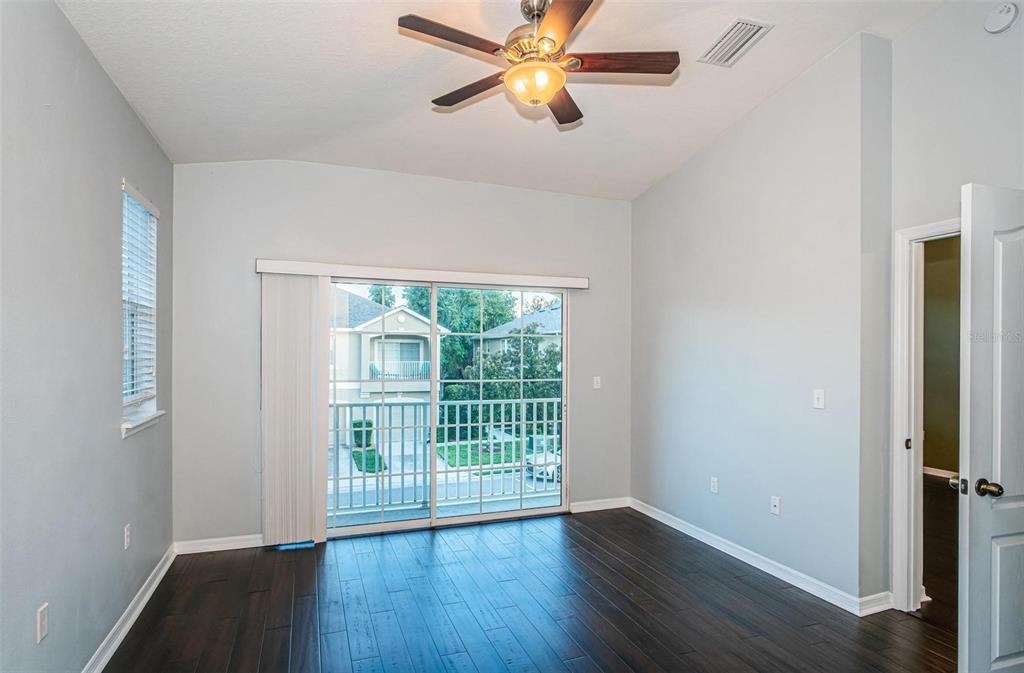 9013 Moonlit Meadows Loop Riverview, FL 33578 - Photo 6 of 43 an empty room with wooden floor fan and windows