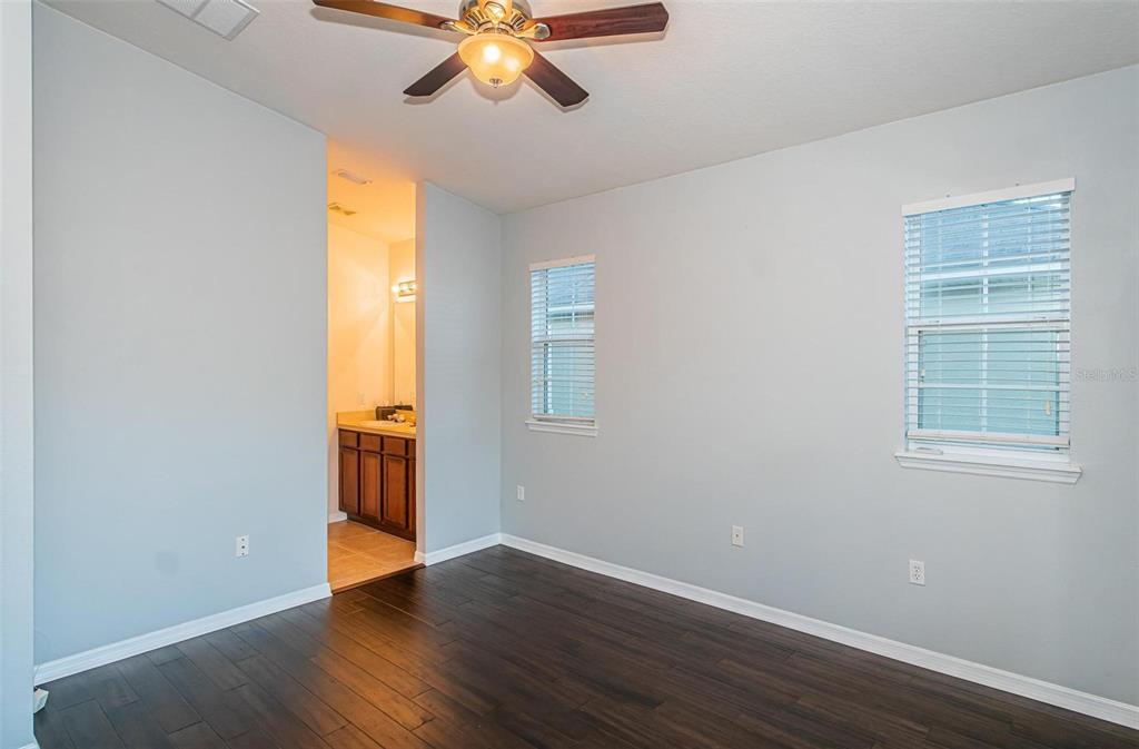 9013 Moonlit Meadows Loop Riverview, FL 33578 - Photo 7 of 43 a view of an empty room with wooden floor and a window