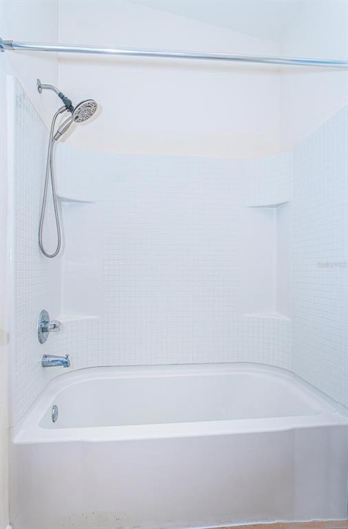 9013 Moonlit Meadows Loop Riverview, FL 33578 - Photo 9 of 43 a bathroom with a shower and a bath tub