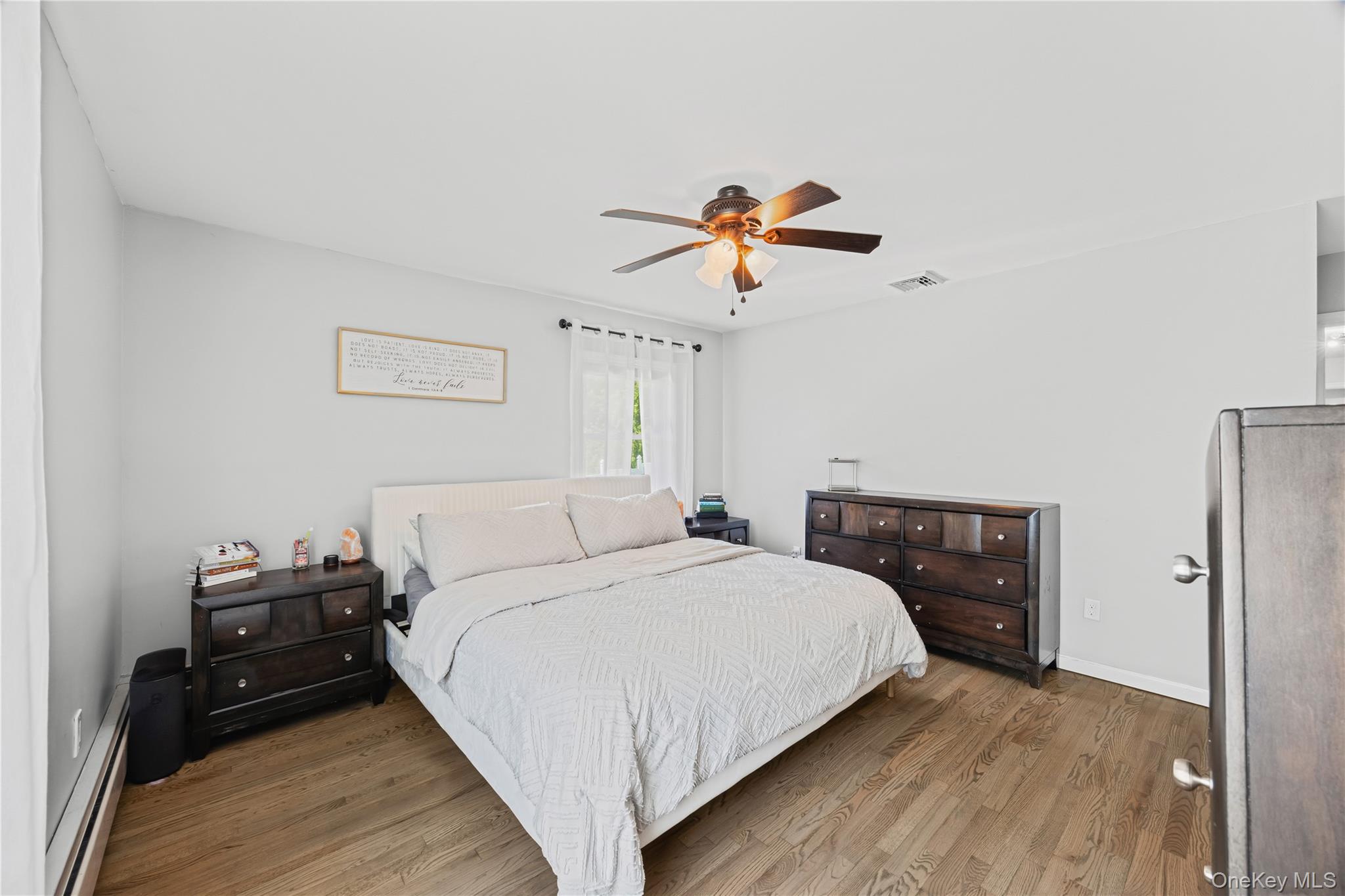 69 Silver Spring Road New Windsor, NY 12553 - Photo 13 of 20 a bedroom with a bed and a chandelier