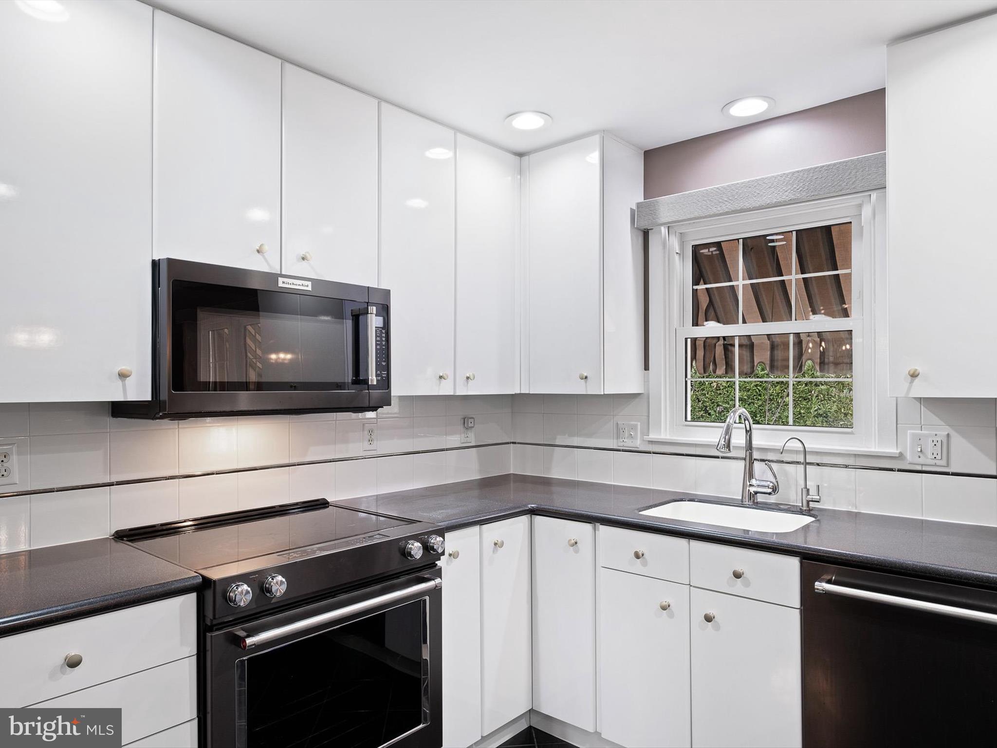 2 Windy Road Wilmington, DE 19810 - Photo 12 of 49 a kitchen with a sink and a microwave