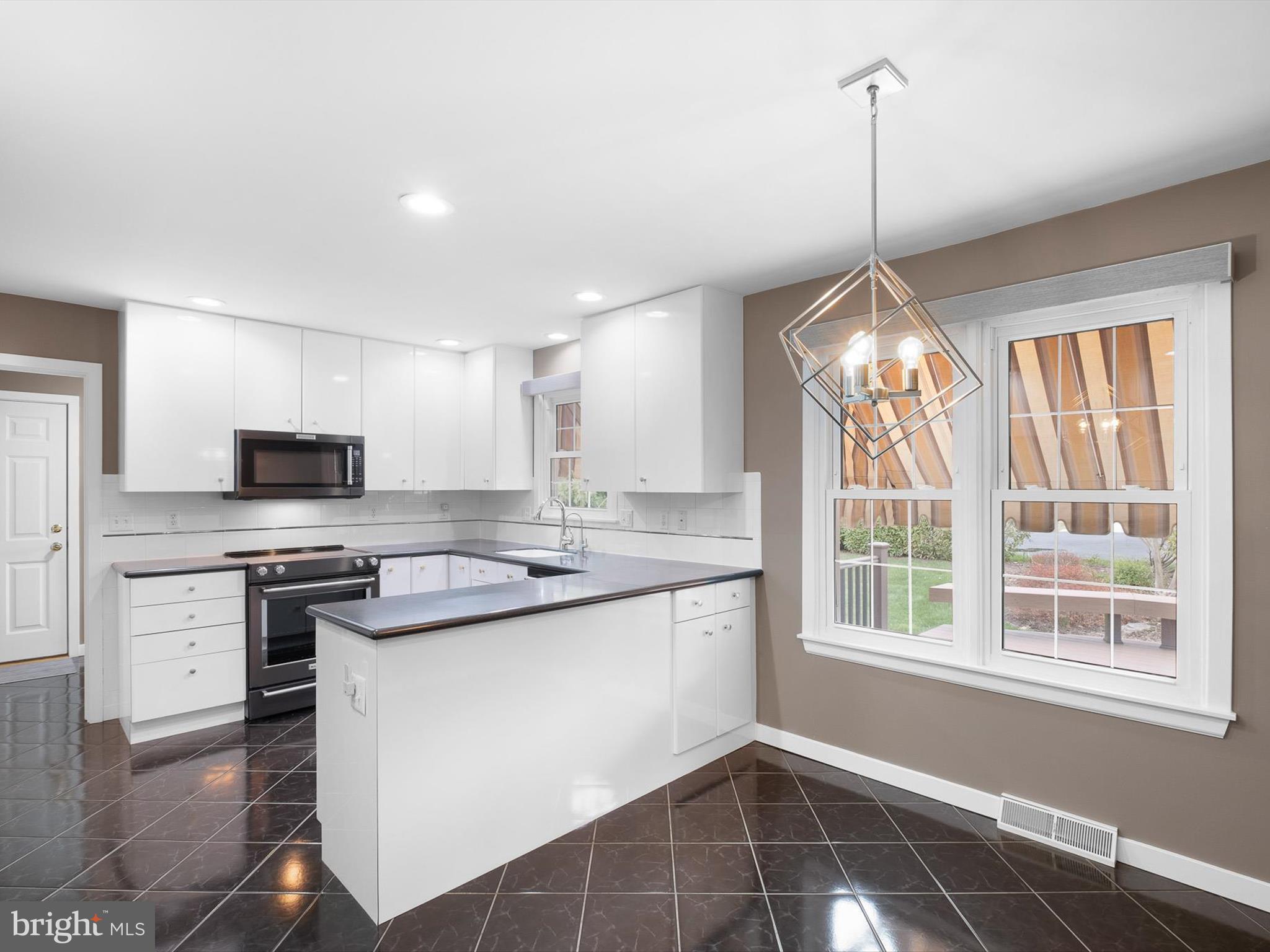 2 Windy Road Wilmington, DE 19810 - Photo 16 of 49 a kitchen with stainless steel appliances granite countertop a stove and a wooden floors