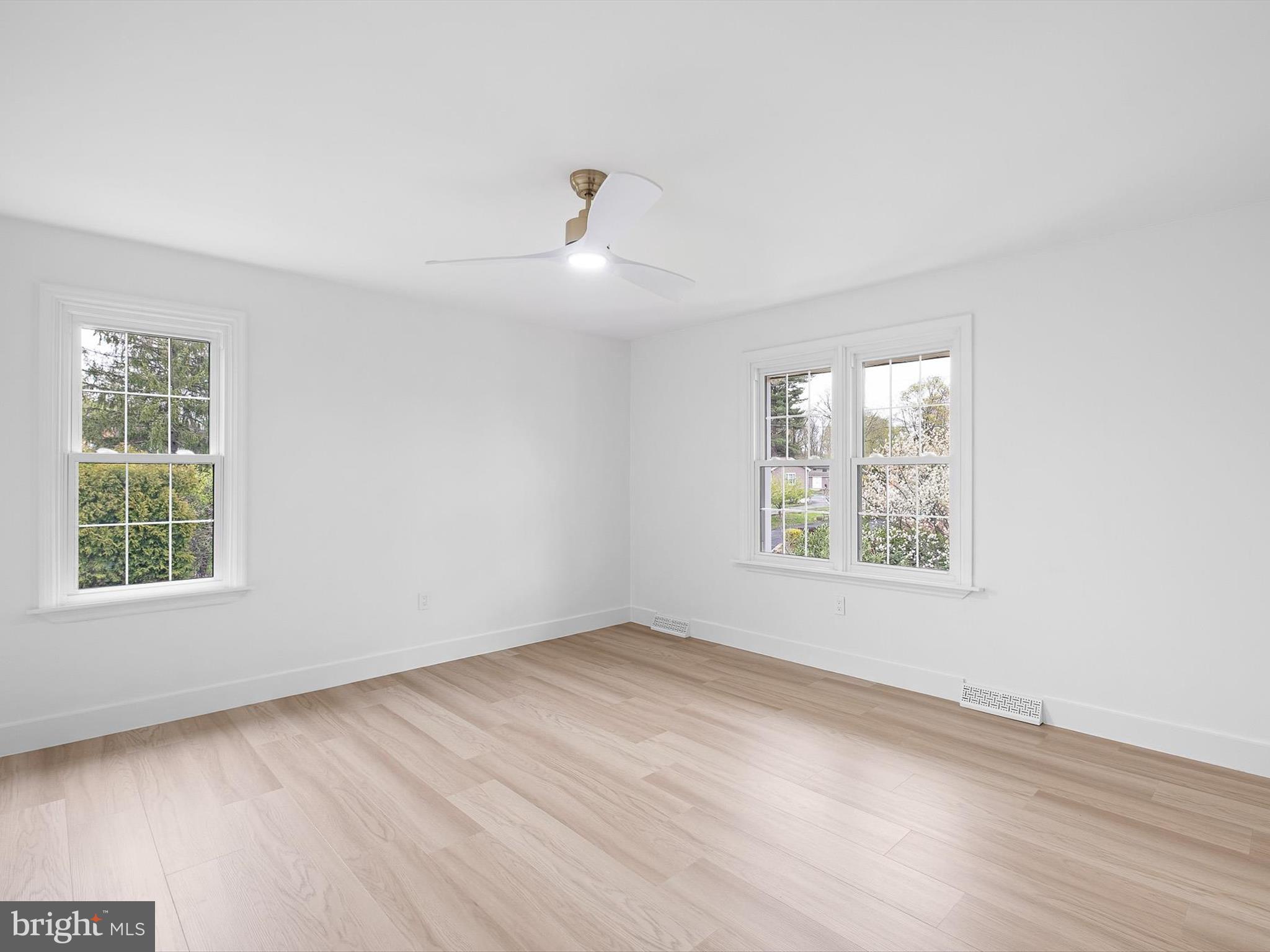 2 Windy Road Wilmington, DE 19810 - Photo 35 of 49 an empty room with wooden floor chandelier fan and windows