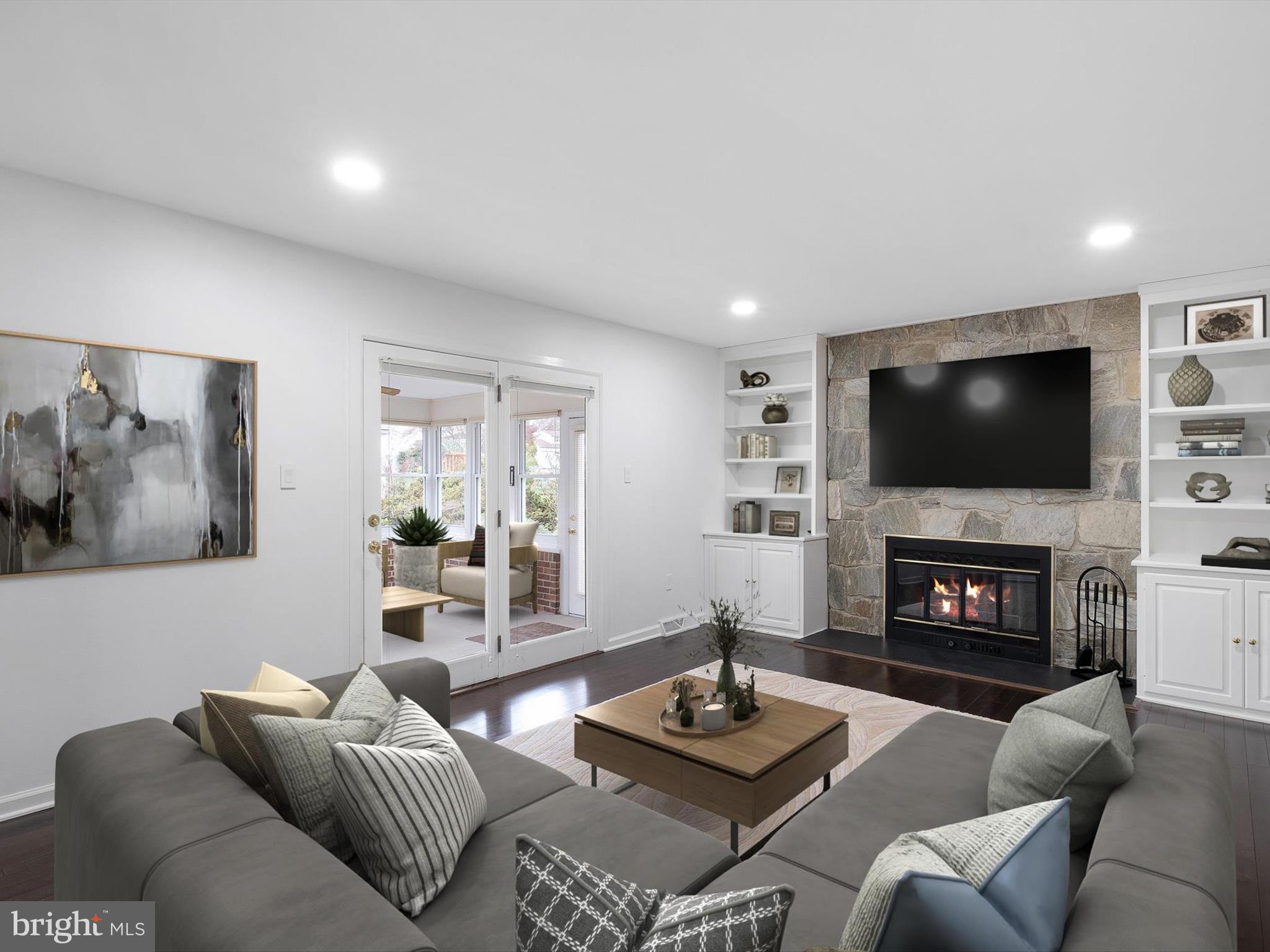 2 Windy Road Wilmington, DE 19810 - Photo 4 of 49 a living room with furniture a fireplace and a flat screen tv