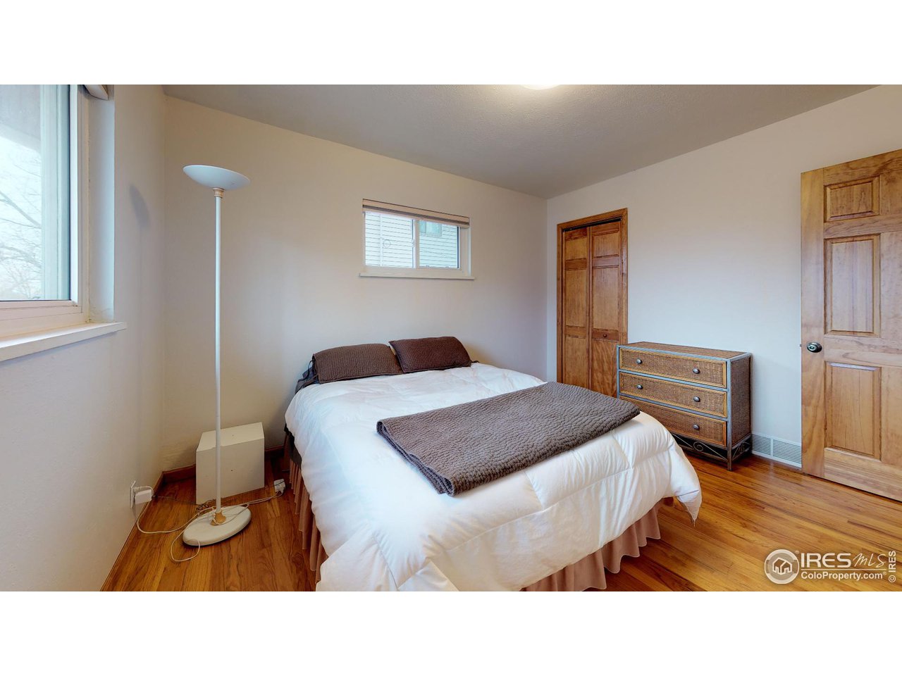 4480 Whitney Place Boulder, CO 80305 - Photo 17 of 17 a bedroom with a bed and a night stand